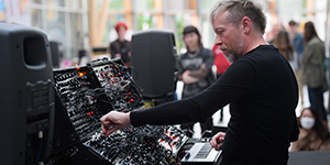 Aaltonen performing with synthesisers in the Herbert Art Gallery & Museum's covered court