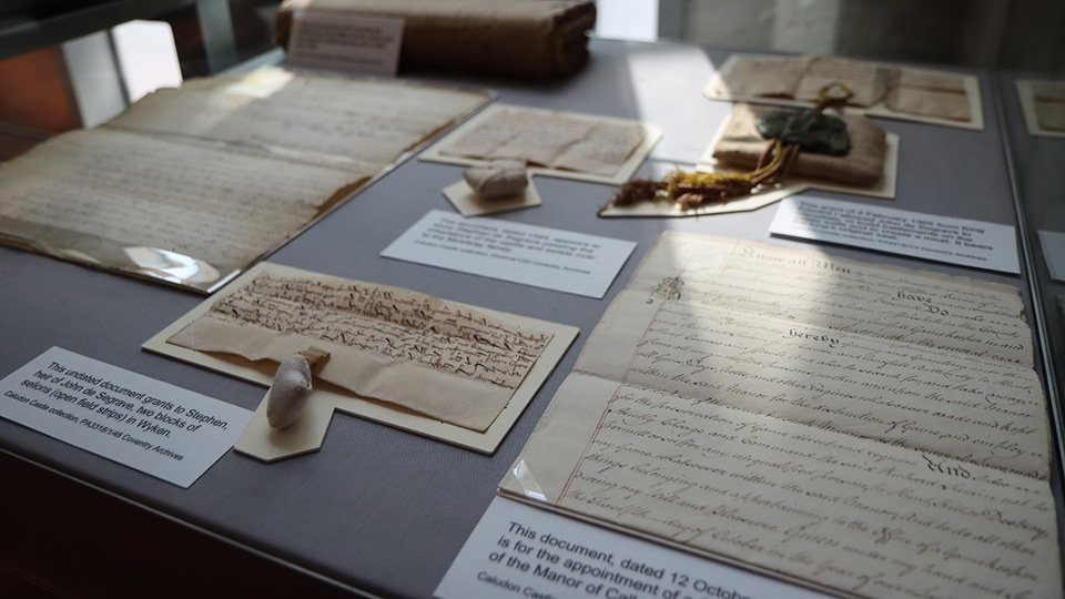 A photograph of a set of Caludon Archive documents on display in the History Centre