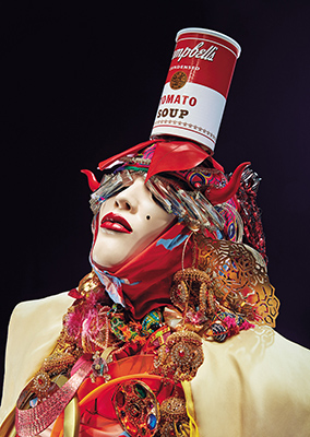 Close up of a Daniel Lismore sculptural headpiece featuring a can of Campbell's tomato soup