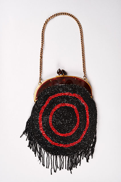 1920s purse with red and black beading and a gold chain 