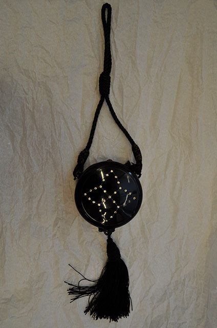 1920s black make up purse with a cord strap and a studded design