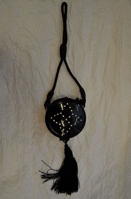 1920s black make up purse with a cord strap and a studded design