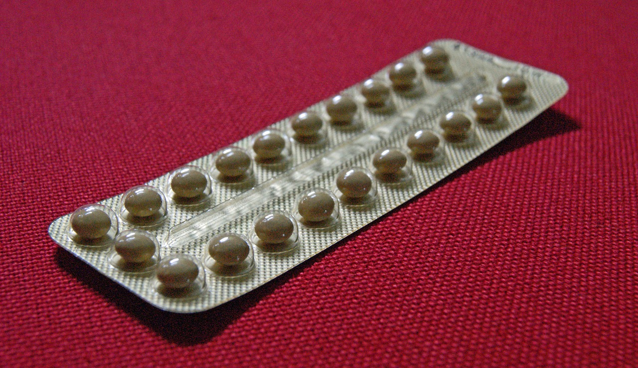 A packet of contraceptive pills laid on a piece of red fabric