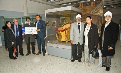 A group of men and women present a giant cheque for £501