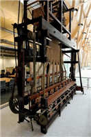 This is a jacquard ribbon weaving loom made by Wilkinson’s of Coventry in 1845 and used at Wm Franflin and Son’s ribbon factory in Coventry until the 1960s. The jacquard loom was invented by Frenchman JM Jacquard in 1801.