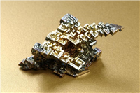 Bismuth. This particular crystal was artificially created in a laboratory. Its distinctive colouring make it a popular and attractive crystal. In its natural form bismuth is a silvery-white metallic element.